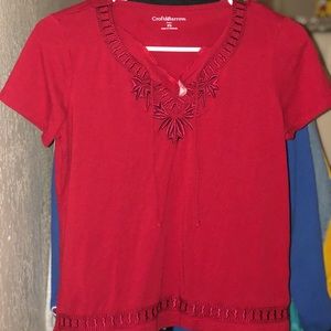 A vibrant red tie up shirt